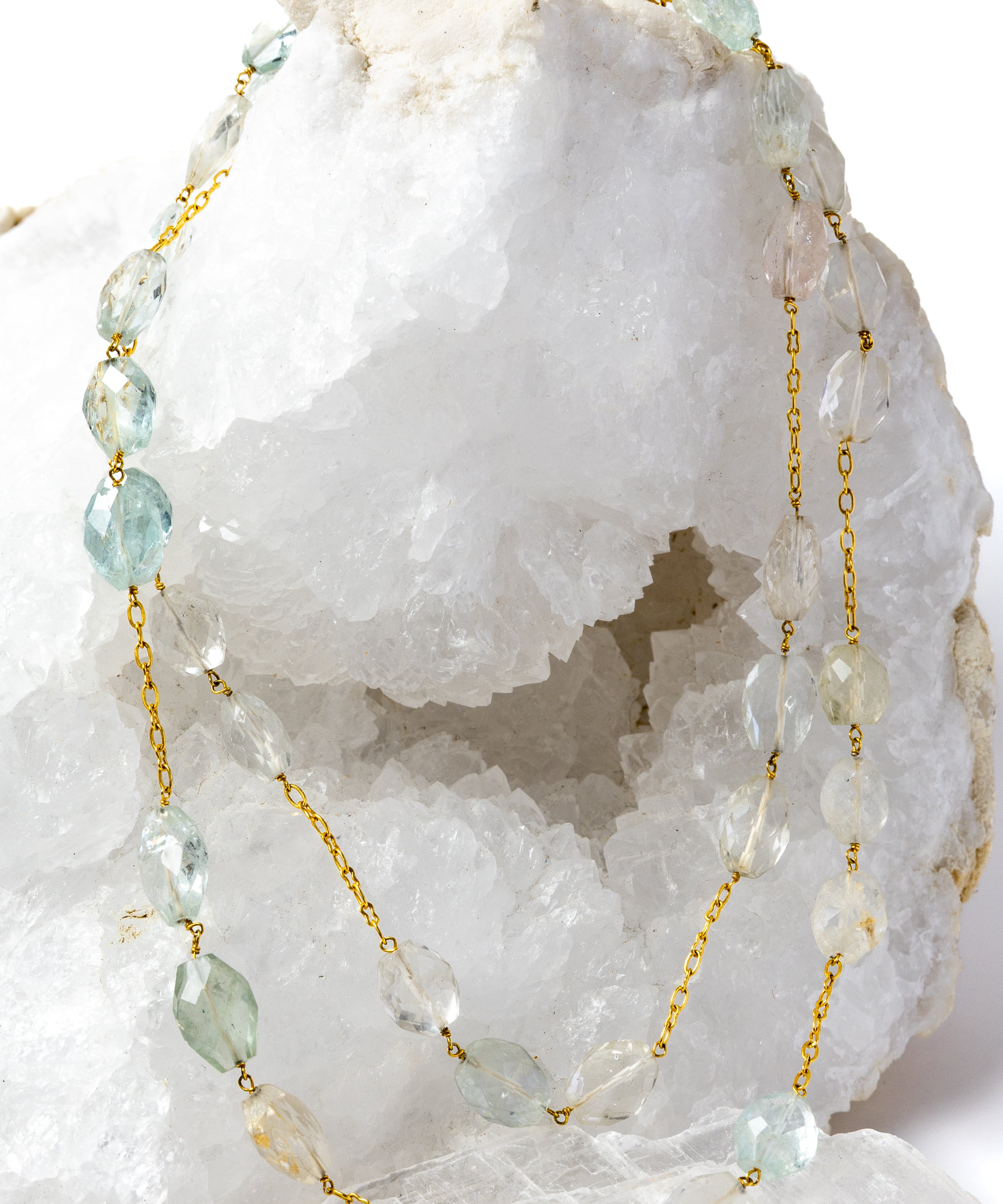 Serenity Mist necklace styled as an elegant two-strand silhouette, showcasing natural faceted aquamarine gemstones and a gold-plated chain with versatile styling.