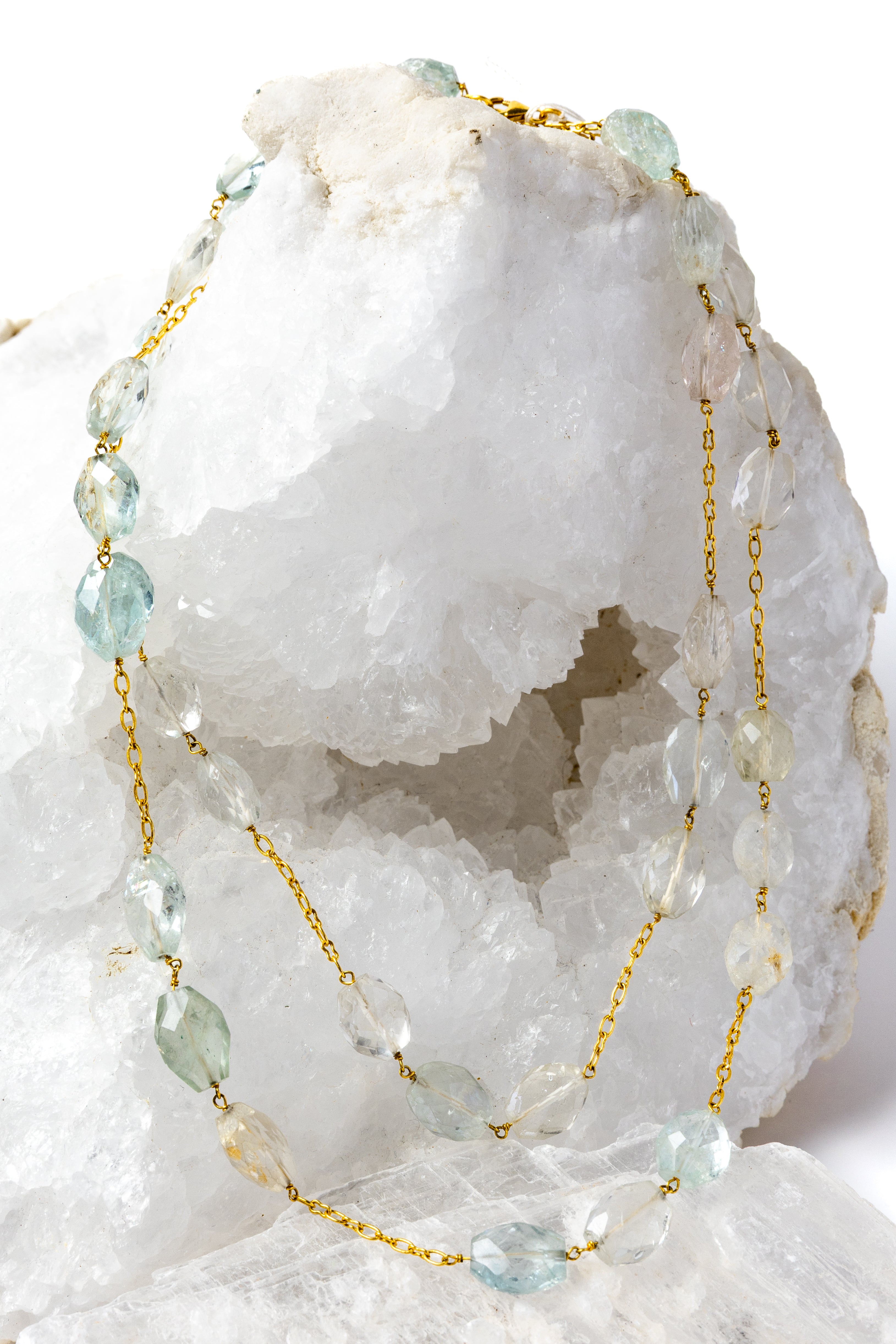 Serenity Mist necklace styled as an elegant two-strand silhouette, showcasing natural faceted aquamarine gemstones and a gold-plated chain with versatile styling.