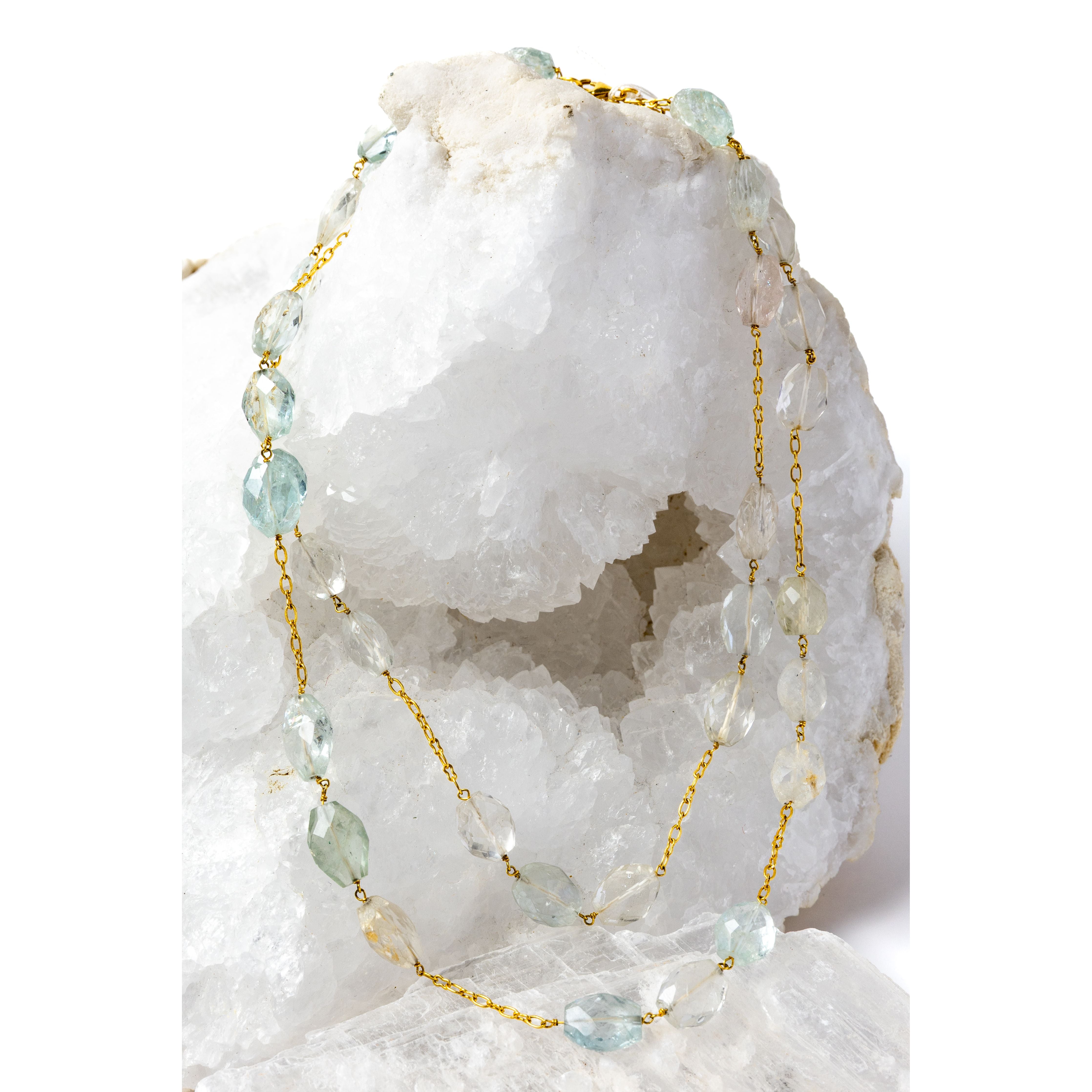 Serenity Mist necklace styled as an elegant two-strand silhouette, showcasing natural faceted aquamarine gemstones and a gold-plated chain with versatile styling.