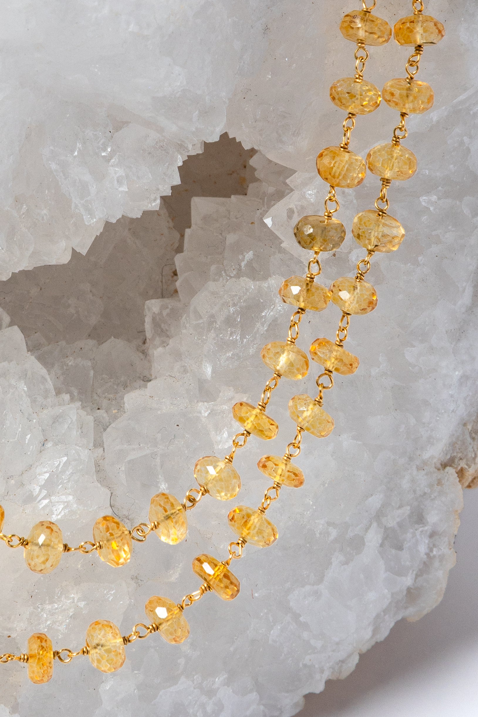 Close-up of faceted natural citrine gemstones showing their intense golden-yellow color, clarity, and luminous brilliance.