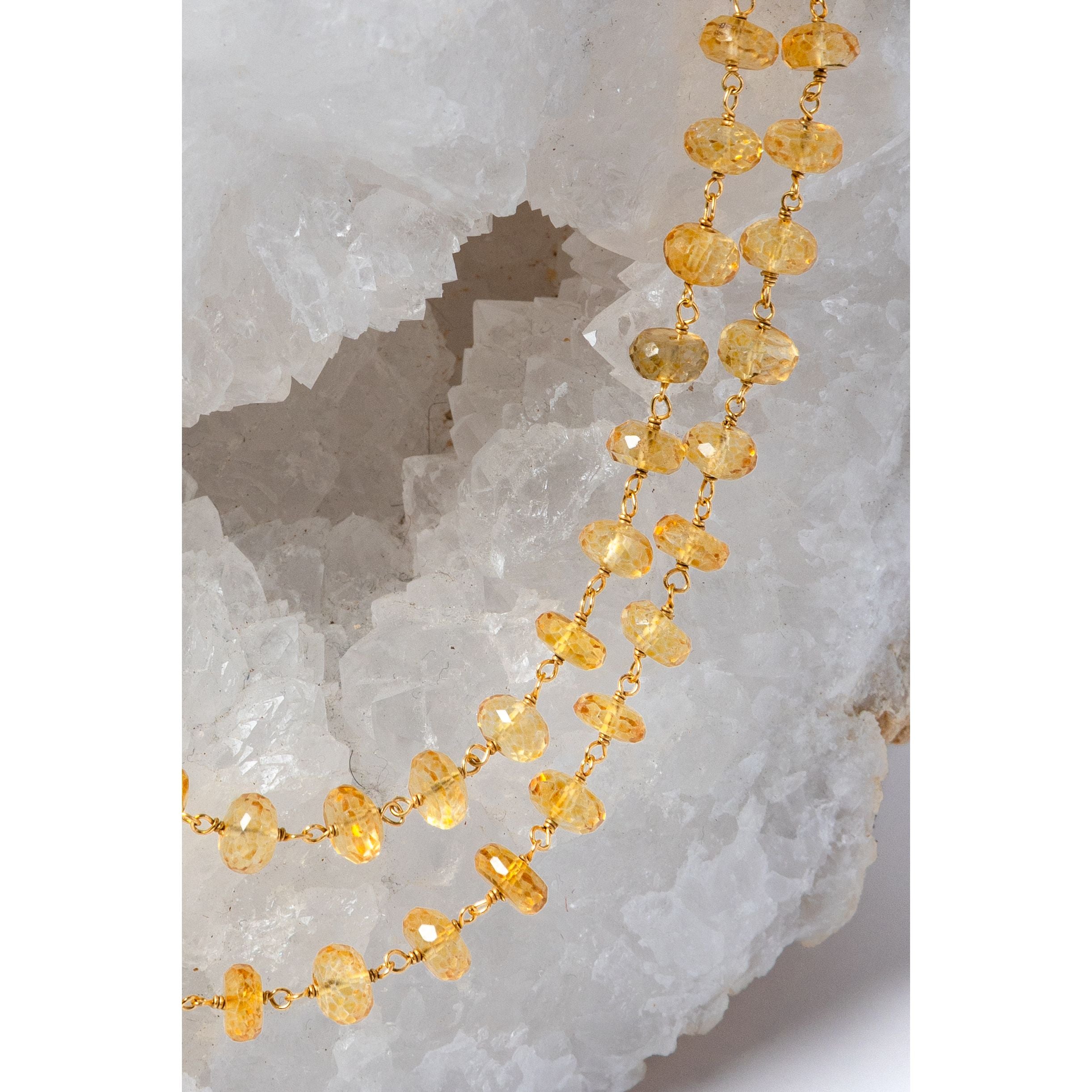 Close-up of faceted natural citrine gemstones showing their intense golden-yellow color, clarity, and luminous brilliance.