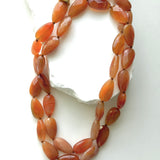 Terracotta Glow milky carnelian necklace styled as a shorter double strand, showcasing its softly opaque faceted gemstones and warm natural color variations.