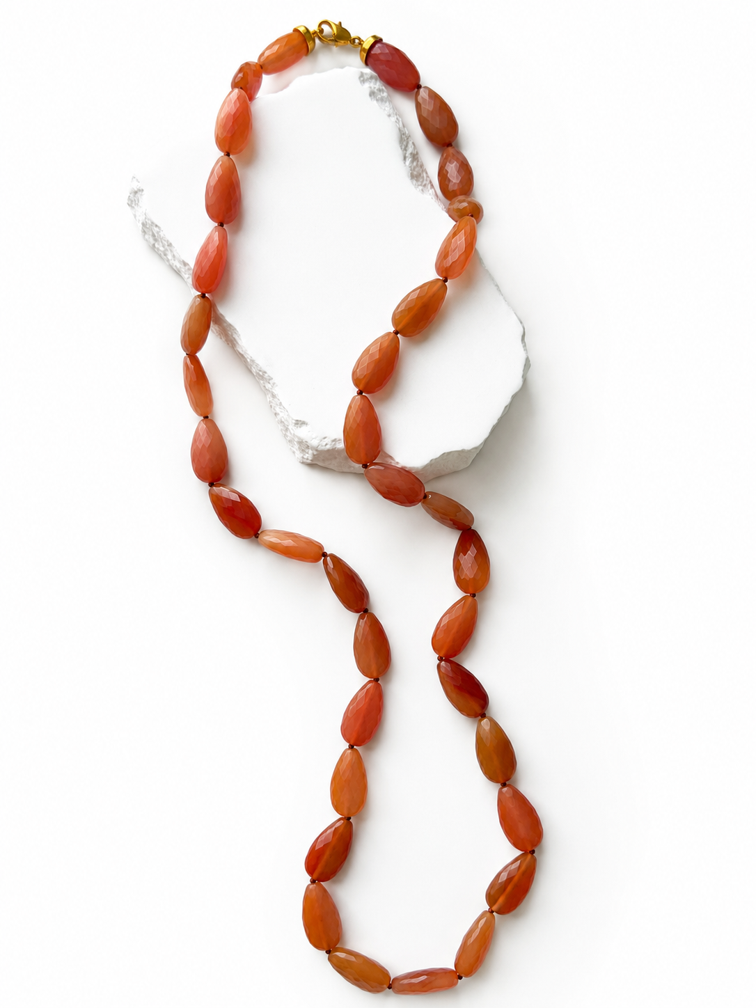 Terracotta Glow 34-inch natural milky carnelian necklace featuring faceted round gemstones in rich terracotta, burnt orange, caramel, and deep reddish tones.