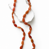 Terracotta Glow 34-inch natural milky carnelian necklace featuring faceted round gemstones in rich terracotta, burnt orange, caramel, and deep reddish tones.