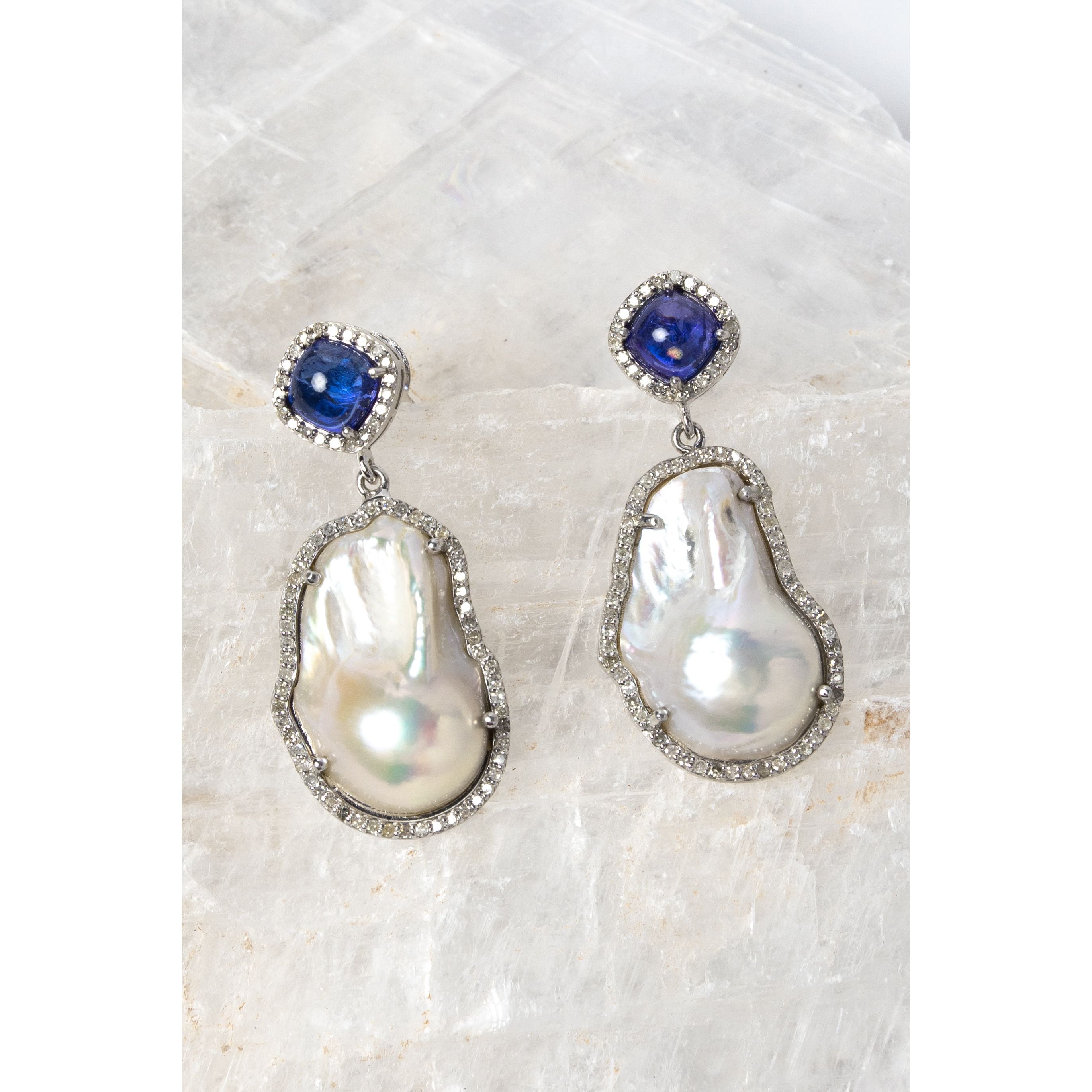 The Empress earrings featuring 4.30 carats of natural tanzanite, 0.90 carats of diamonds, lustrous baroque pearls, and sterling silver in an elegant statement design.