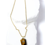 Natural Tiger Eye Gem Charm Necklace featuring a faceted golden-brown gemstone pendant with a cubic zirconia accent suspended from a gold-plated beaded chain