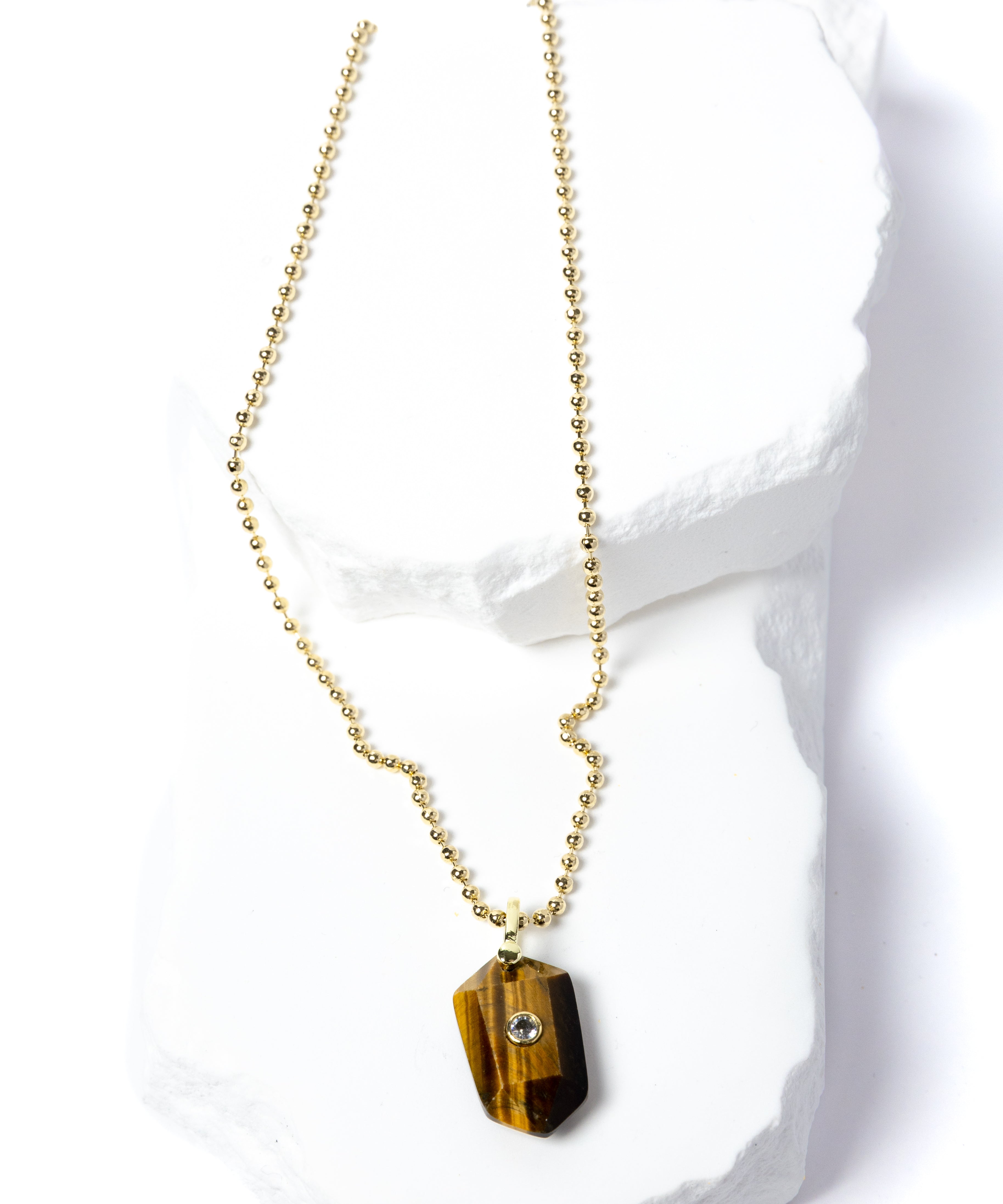 Natural Tiger Eye Gem Charm Necklace featuring a faceted golden-brown gemstone pendant with a cubic zirconia accent suspended from a gold-plated beaded chain