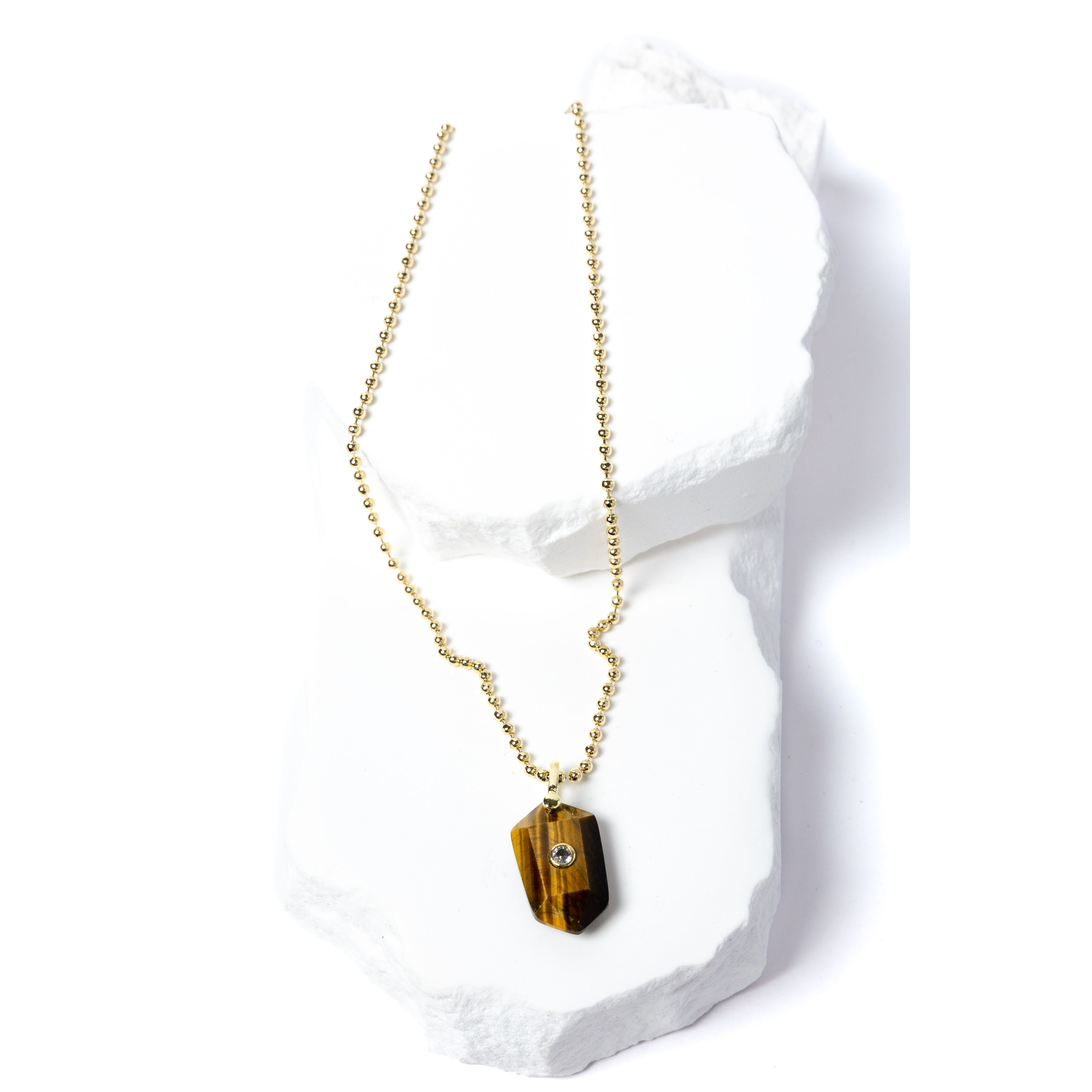 Natural Tiger Eye Gem Charm Necklace featuring a faceted golden-brown gemstone pendant with a cubic zirconia accent suspended from a gold-plated beaded chain