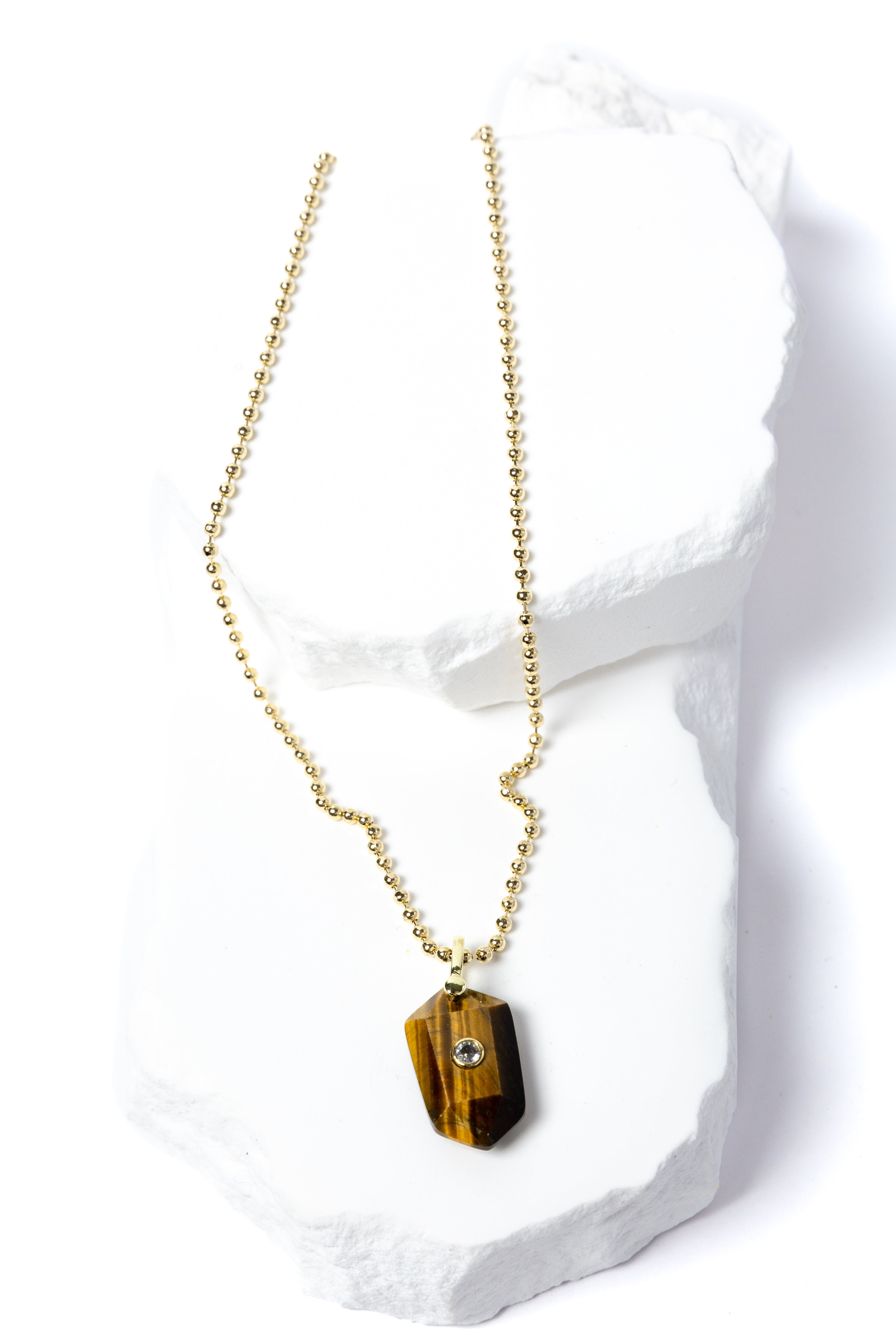 Natural Tiger Eye Gem Charm Necklace featuring a faceted golden-brown gemstone pendant with a cubic zirconia accent suspended from a gold-plated beaded chain