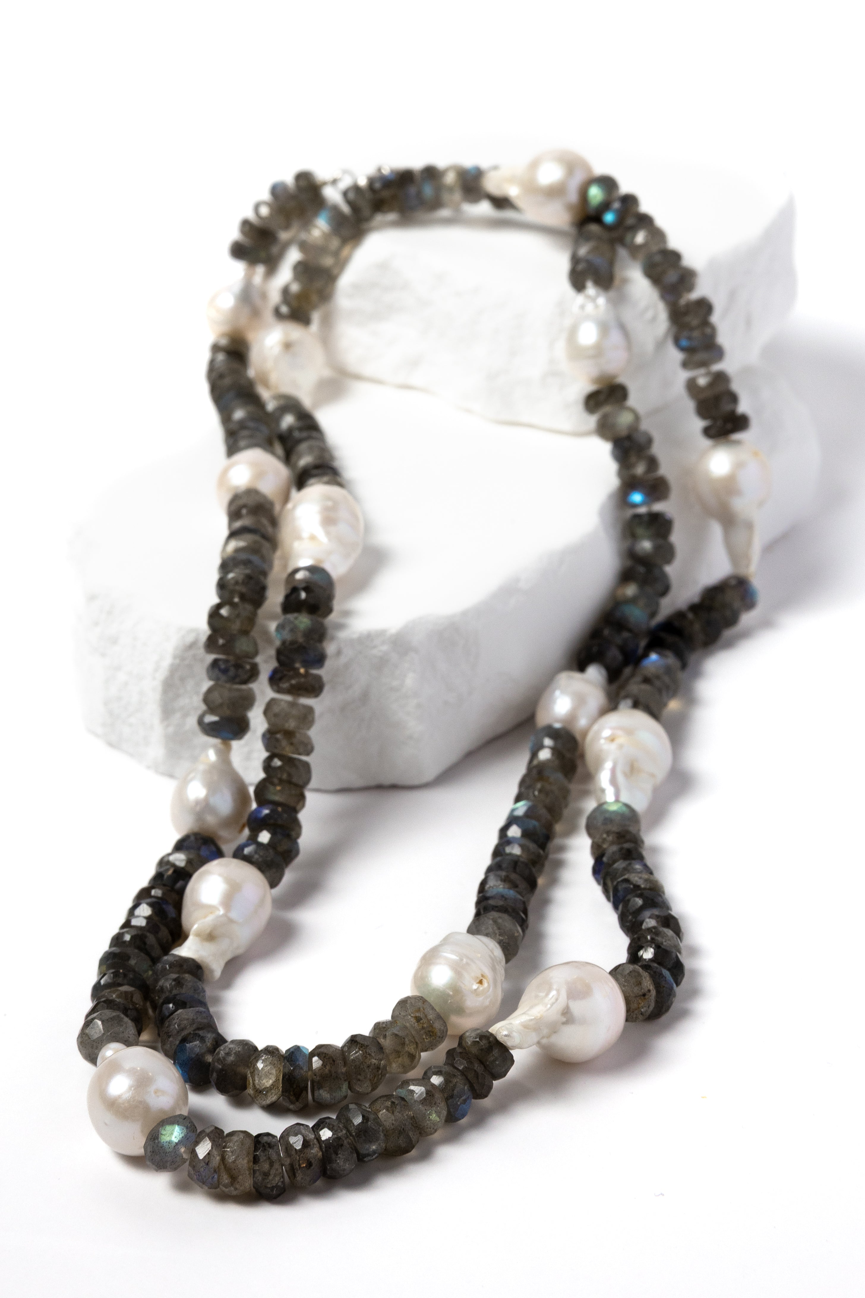 Twilight labradorite and baroque pearl necklace styled as a shorter two-strand necklace, showcasing the contrast of smoky faceted gemstones and luminous pearls.