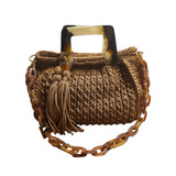Hand-crocheted Giselle handbag in a warm cognac tone with dimensional vertical textured stitching, featuring marbled amber resin round handles and a coordinating chain strap.