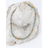 Watercolor Necklace handcrafted with natural calcite disc beads in soft blue and naturally varied tones, accented with warm gold-plated details.