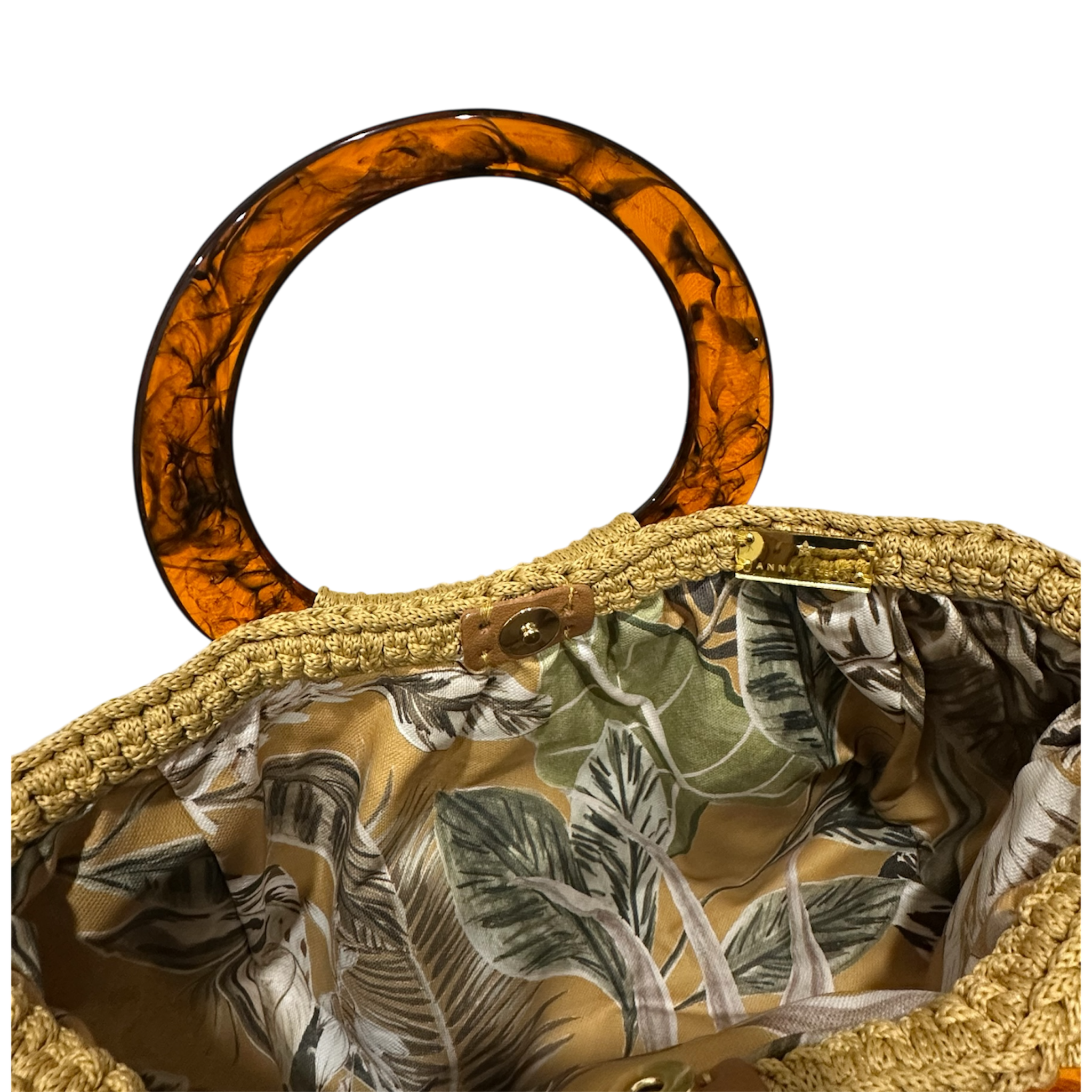 Hand-crocheted luxury handbag interior with botanical lining and spacious open design, featuring dimensional crochet texture, sculptural resin handle and refined chain detail