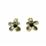 Romantic floral earrings featuring brushed gold-plated petals surrounding polished black onyx cabochons in a soft sculptural flower design.