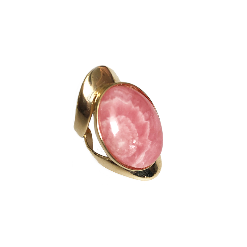Allure statement ring featuring a natural 25 × 18 mm rhodochrosite cabochon with beautiful shades of blush, rose, and warm pink in a sculptural gold-plated setting, ergonomically designed for exceptional comfort.