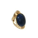 Allure statement ring featuring a natural 25 × 18 mm sodalite cabochon with rich navy and royal blue hues in a sculptural gold-plated setting, ergonomically designed for exceptional comfort.